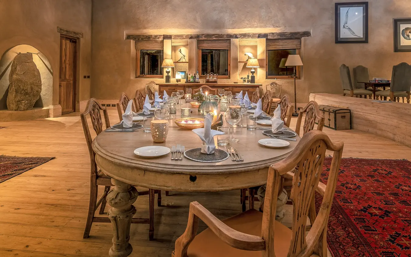 Long dining table set for formal dinner service, Lengishu House, Laikipia Highlands, Kenya