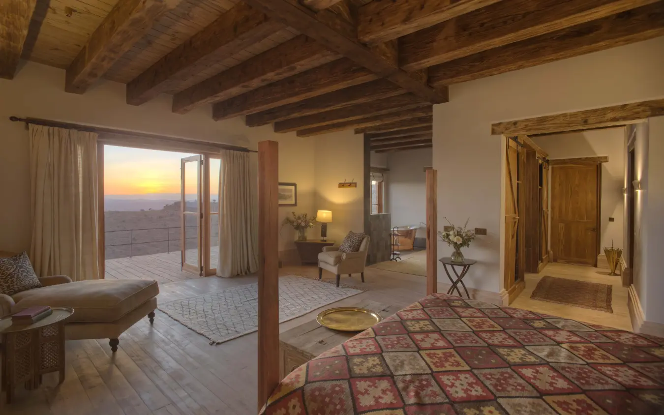 Spacious bedroom with sunset views from terrace doors, Lengishu House, Laikipia Highlands, Kenya