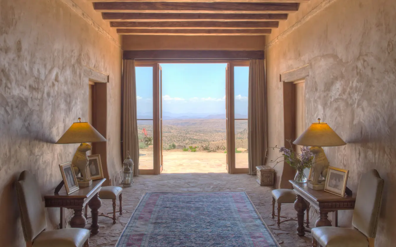 Symmetrical interior hallway with view to vast landscape, Lengishu House, Laikipia Highlands, Kenya