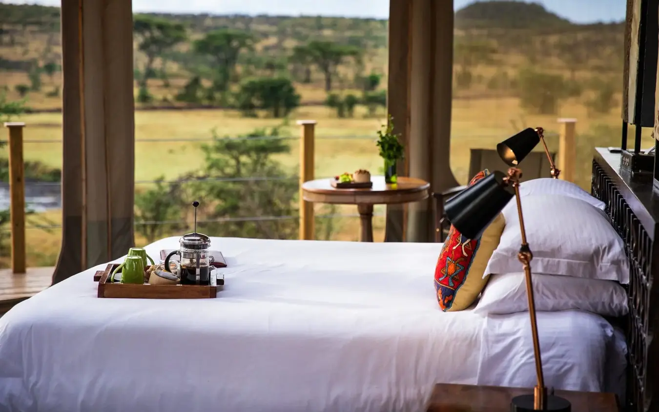 Bedroom with telescope and landscape view over savanna plains, Leopard Hill, Maasai Mara, Kenya