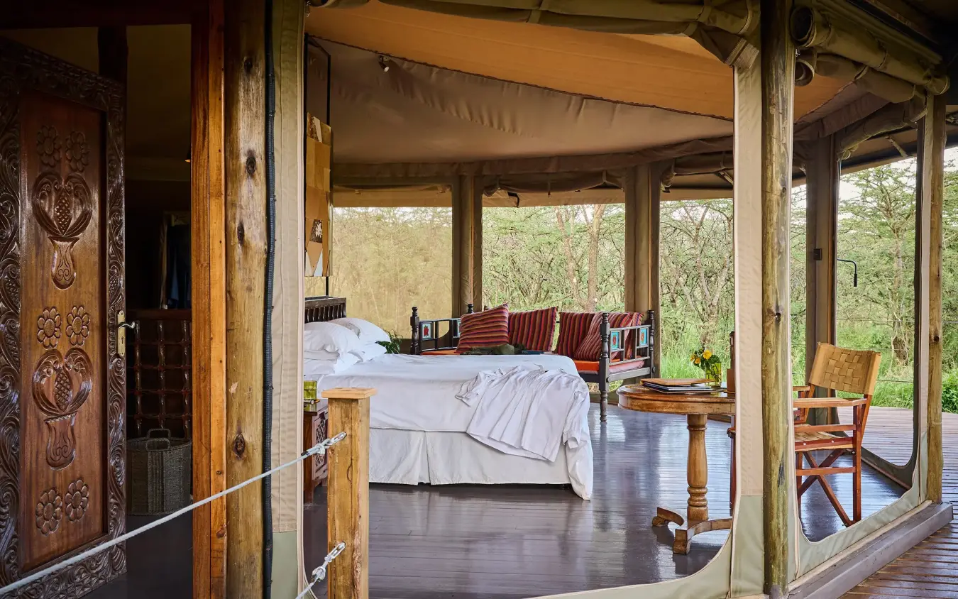 Luxury safari tent bedroom with views of woodland landscape, Leopard Hill, Maasai Mara, Kenya