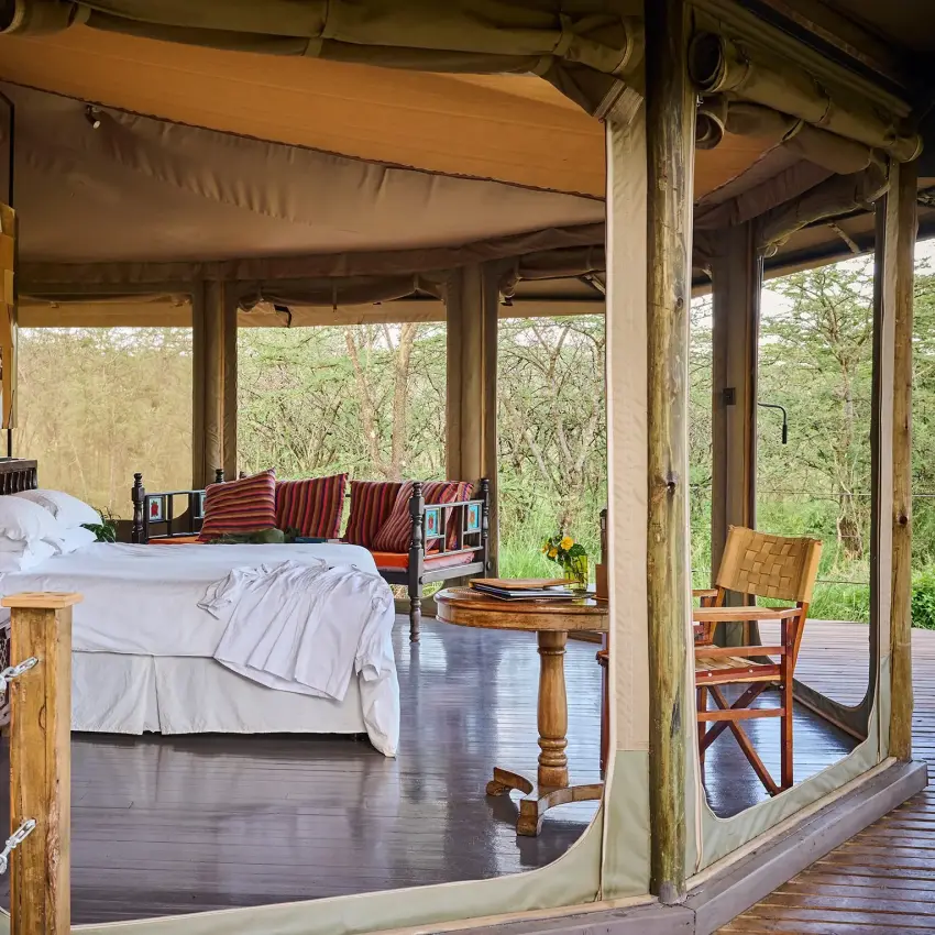 Luxury safari tent bedroom with views of woodland landscape, Leopard Hill, Maasai Mara, Kenya