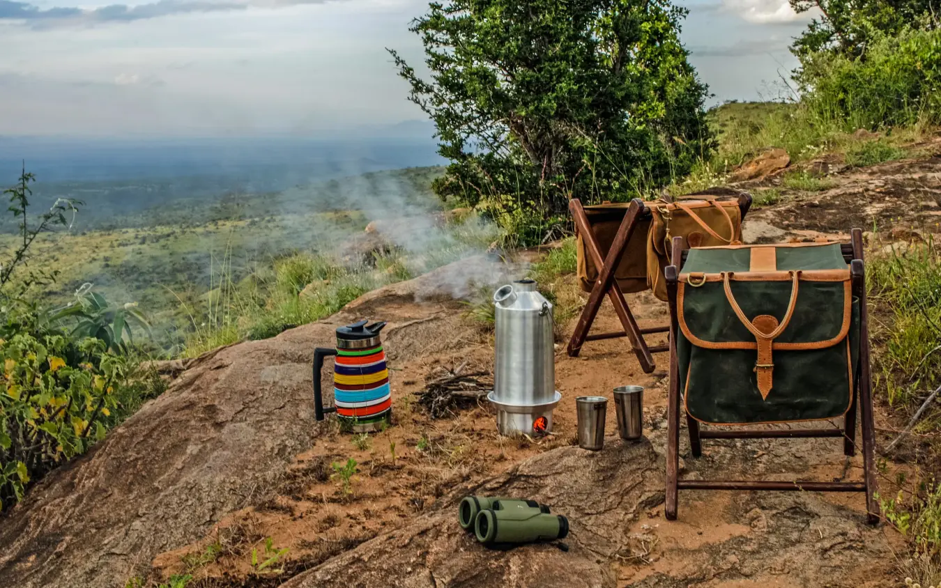 Hillside camping setup overlooking expansive valley landscape, Lewa House, Laikipia Highlands, Kenya
