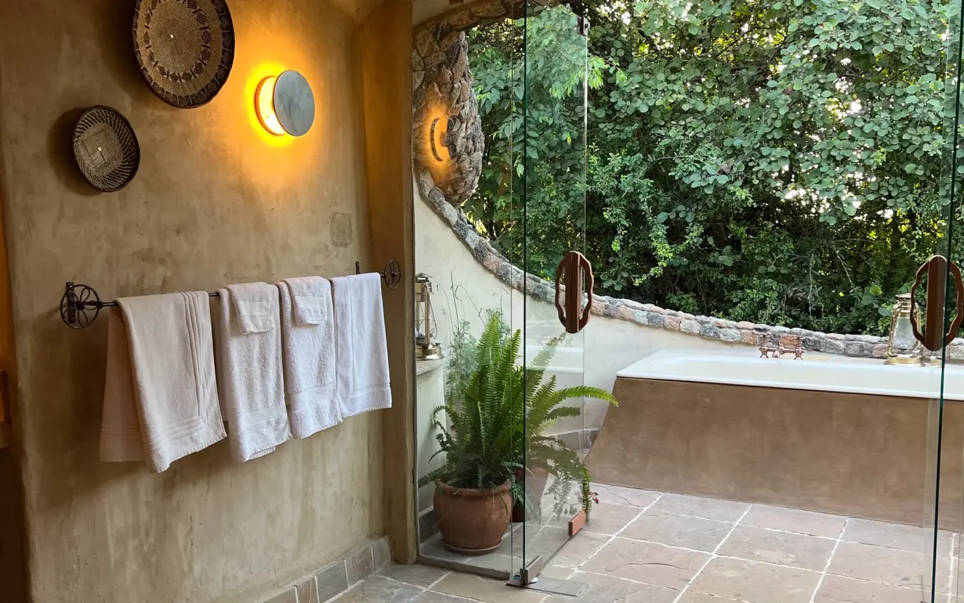 Luxurious bathroom with soaking tub and natural vegetation views, Lewa House, Laikipia Highlands, Kenya