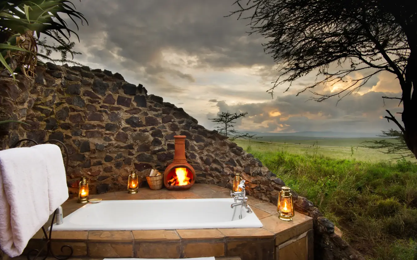 Outdoor bathtub on stone deck overlooking savanna landscape, Lewa House, Laikipia Highlands, Kenya