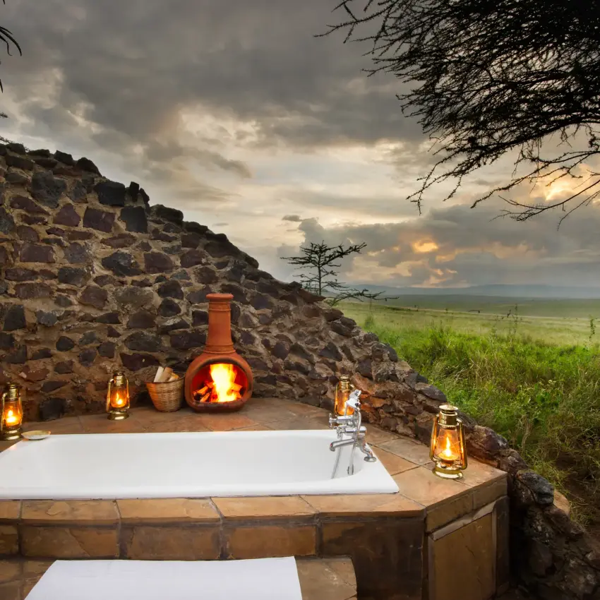 Outdoor bathtub on stone deck overlooking savanna landscape, Lewa House, Laikipia Highlands, Kenya