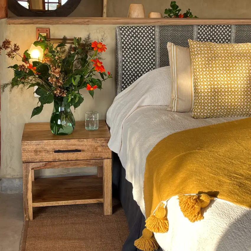 Bedroom interior with wooden furniture and earth tones, Lewa House, Laikipia Highlands, Kenya