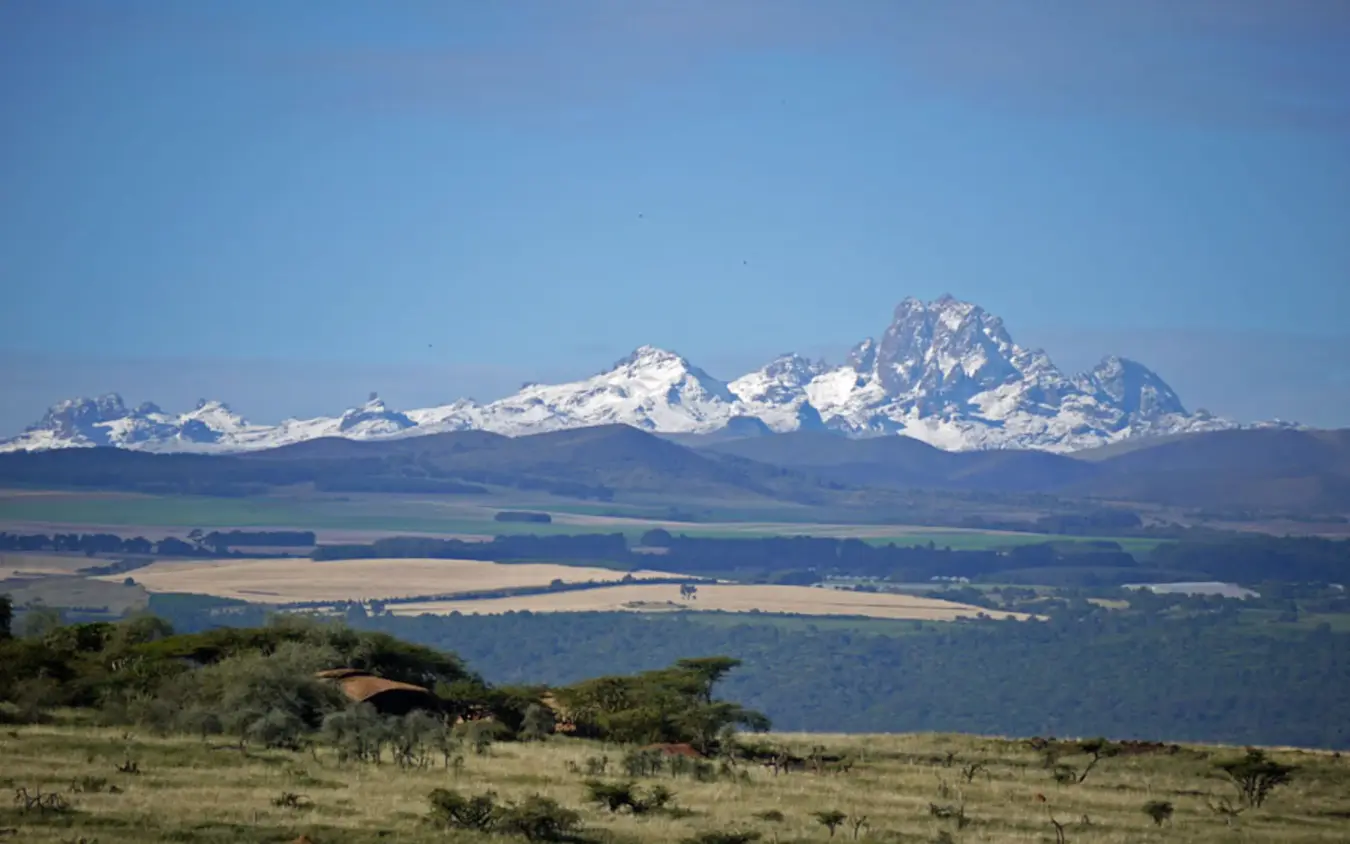 Snow-capped Mount Kenya rising above savanna grassland, Lewa House, Laikipia Highlands, Kenya