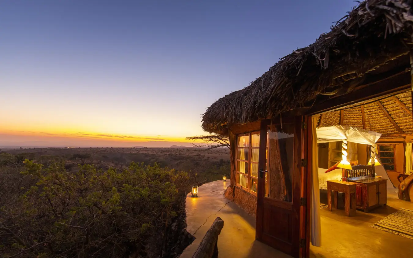 Thatched lodge deck overlooking savanna at sunset, Lewa Wilderness, Laikipia Highlands, Kenya