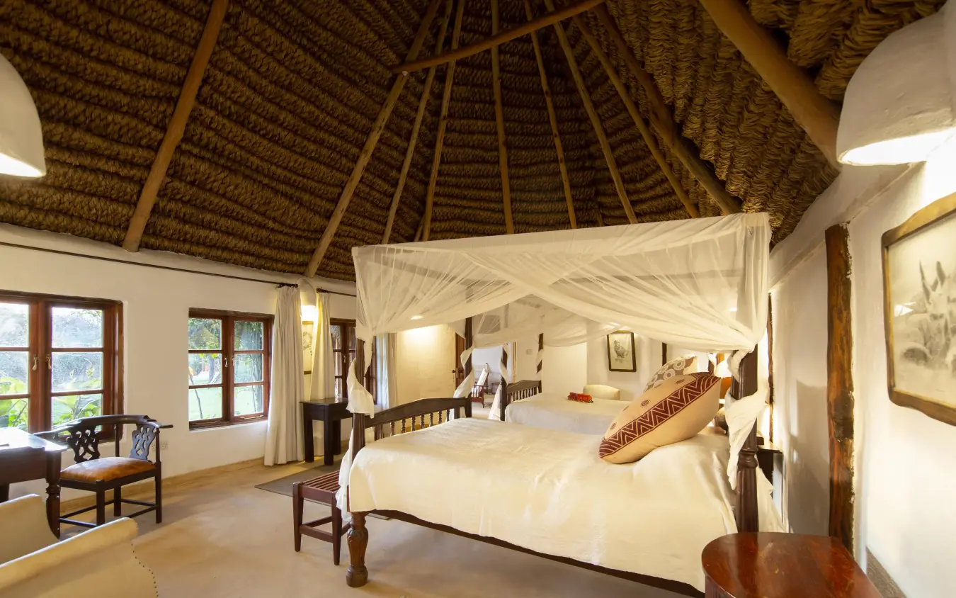 Spacious bedroom with thatched roof and canopy bed, Lewa Wilderness, Laikipia Highlands, Kenya