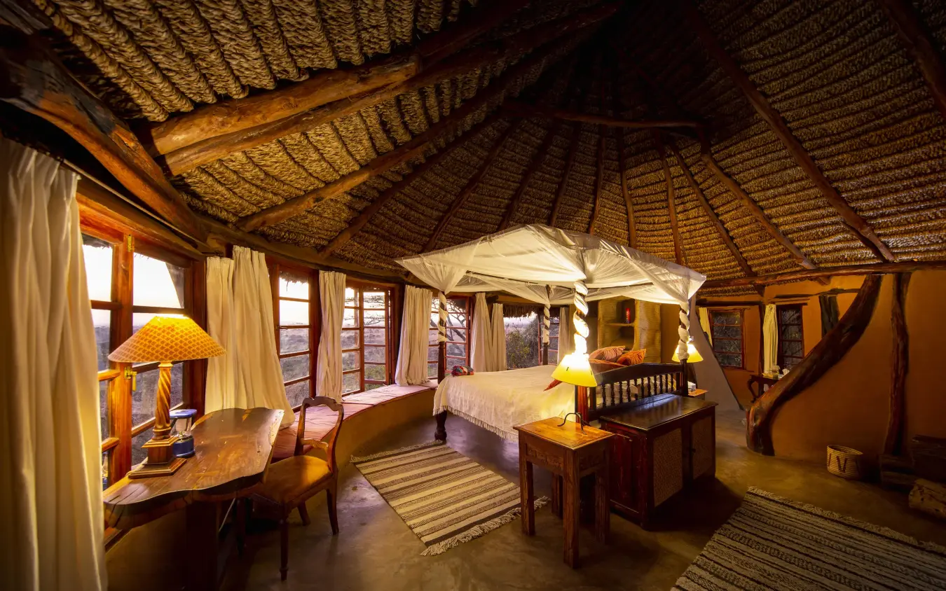 Spacious safari bedroom with thatched roof and four-poster bed, Lewa Wilderness, Laikipia Highlands, Kenya