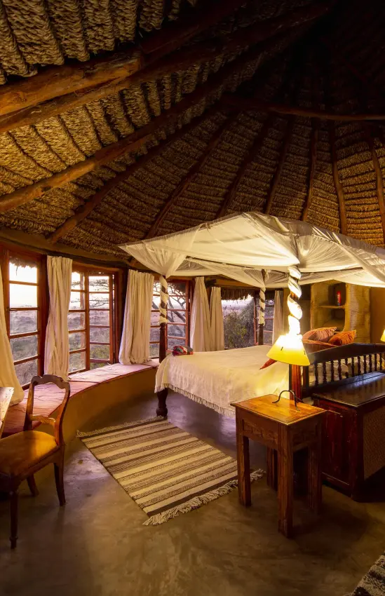 Spacious safari bedroom with thatched roof and four-poster bed, Lewa Wilderness, Laikipia Highlands, Kenya