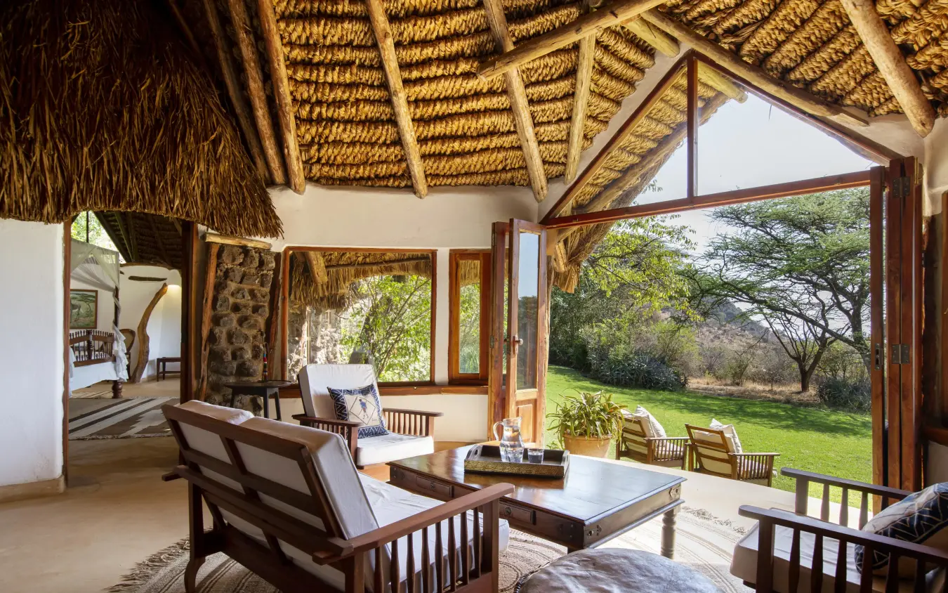 Open-air lounge with thatched roof overlooking savanna landscape, Lewa Wilderness, Laikipia Highlands, Kenya
