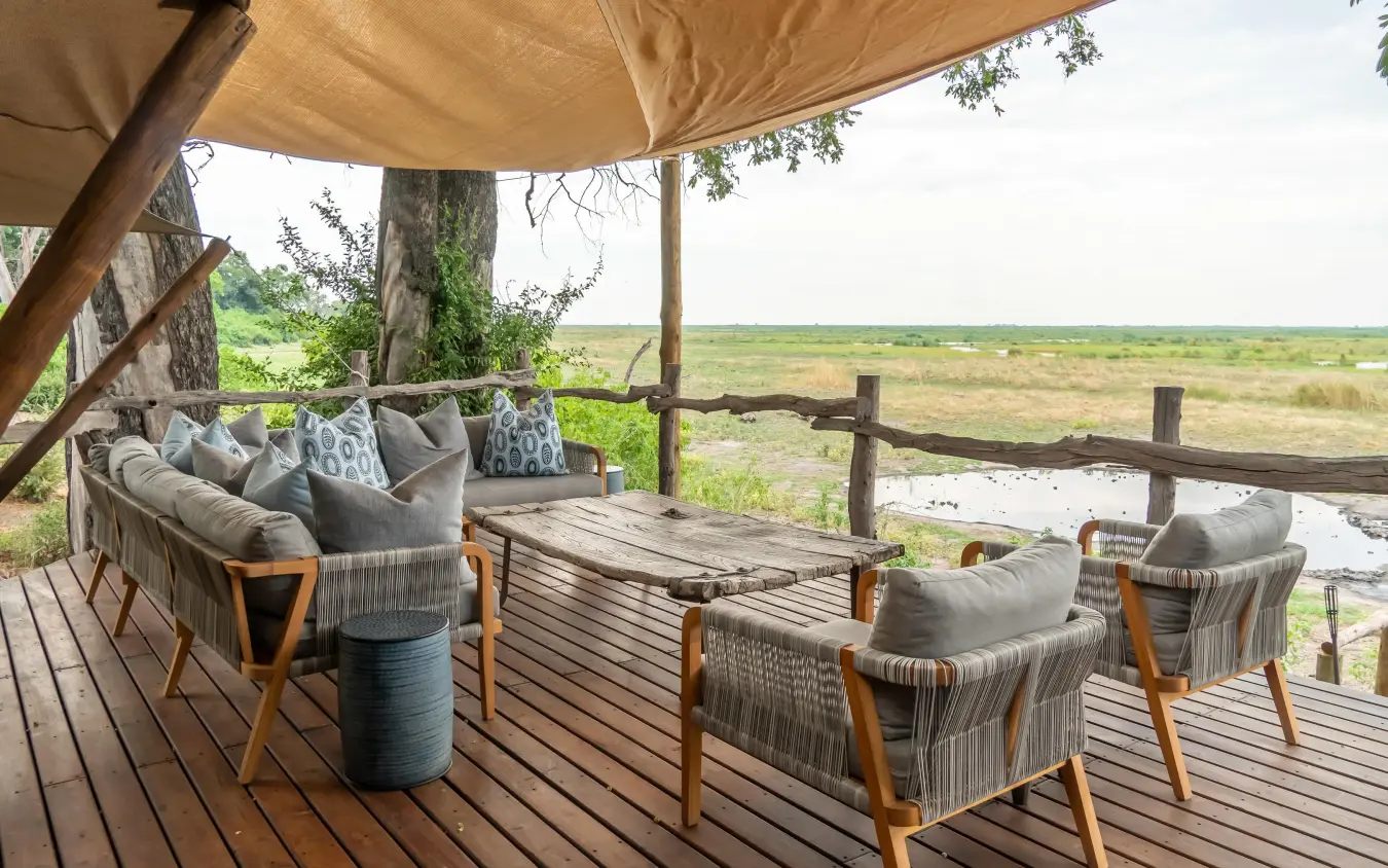 Wooden deck with seating overlooking wetland landscape, Linyanti Bush Camp, Linyanti Wildlife Reserve, Botswana