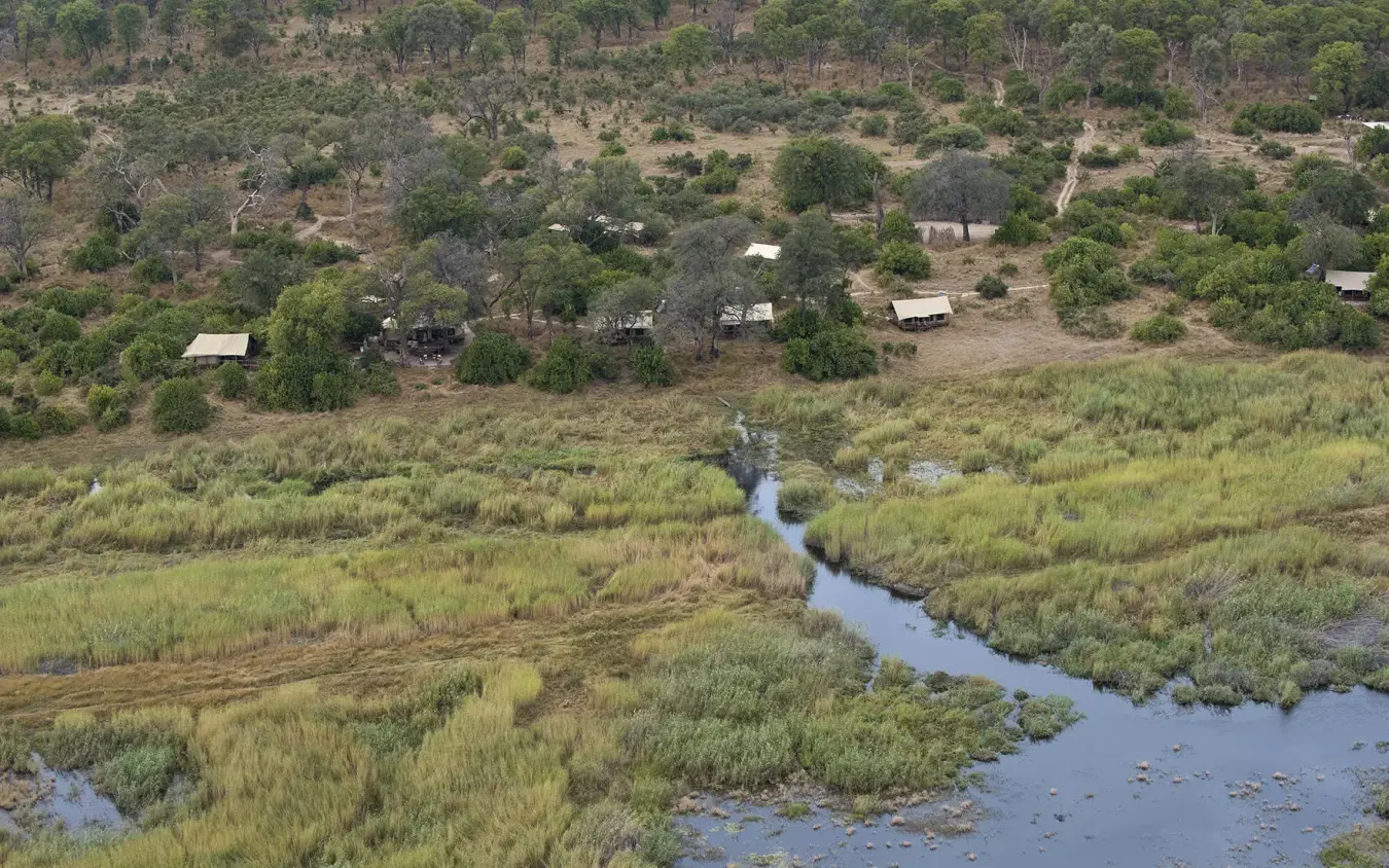 Aerial view of river winding through grassland and woodland, Linyanti Ebony, Linyanti Wildlife Reserve, Botswana