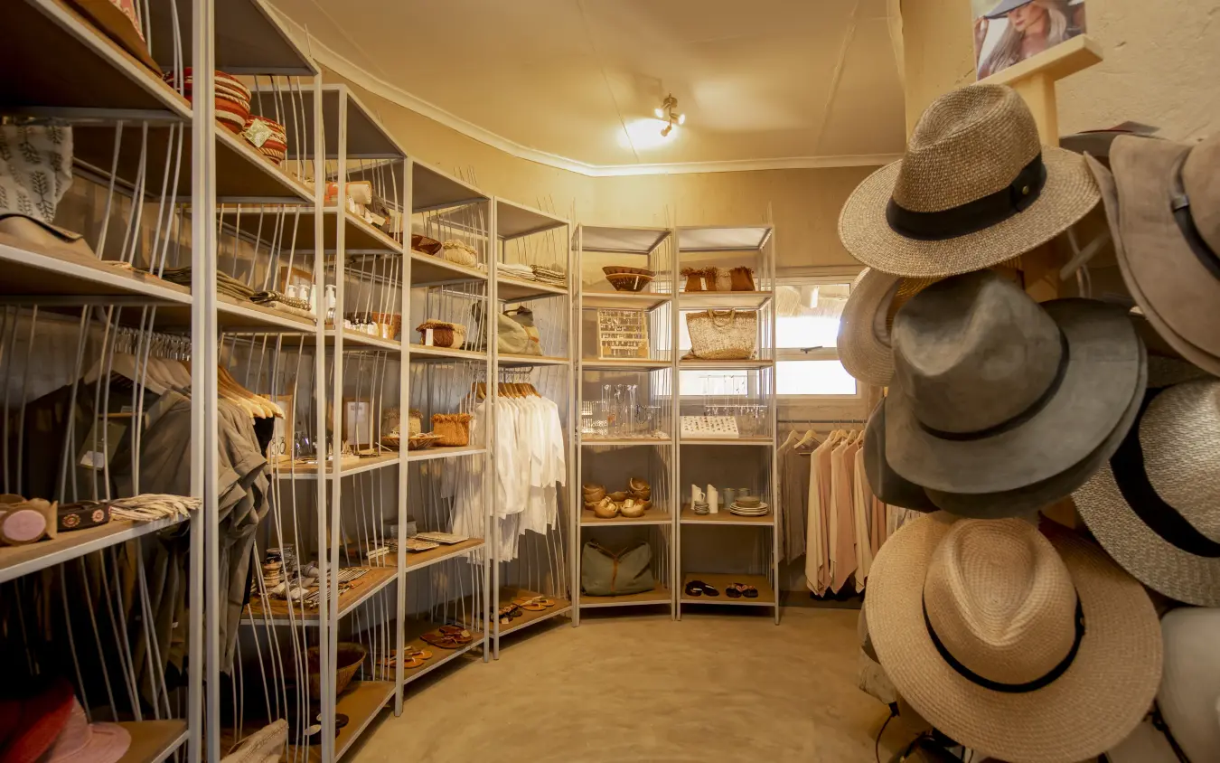 Luxury walk-in closet with organized shelving and straw hats on display, Little Kulala, Sossusvlei, Namibia