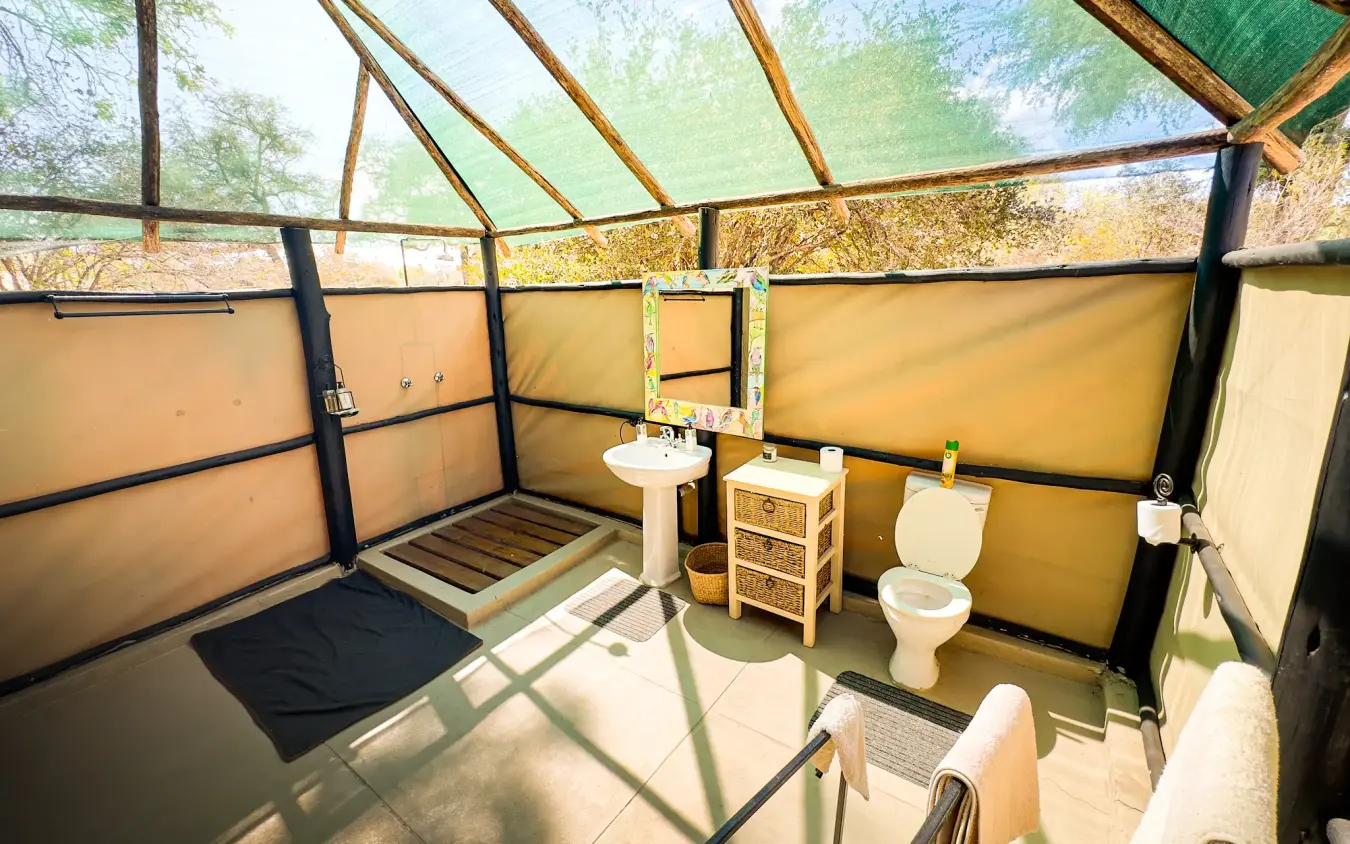 Open-air bathroom with glass roof and safari views, Little Vundu, Mana Pools, Zimbabwe