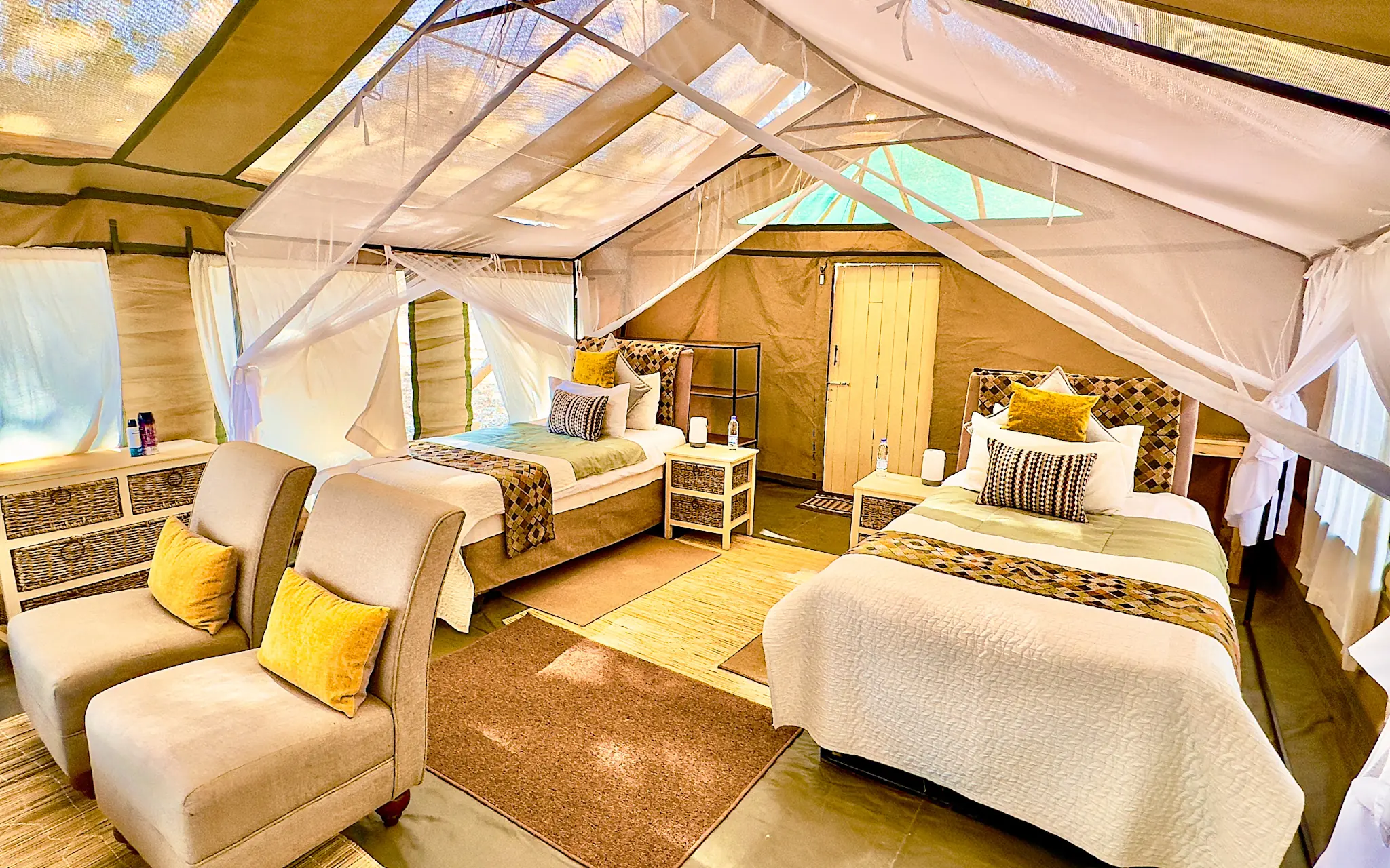 Spacious safari tent bedroom with two beds and seating area, Little Vundu, Mana Pools, Zimbabwe