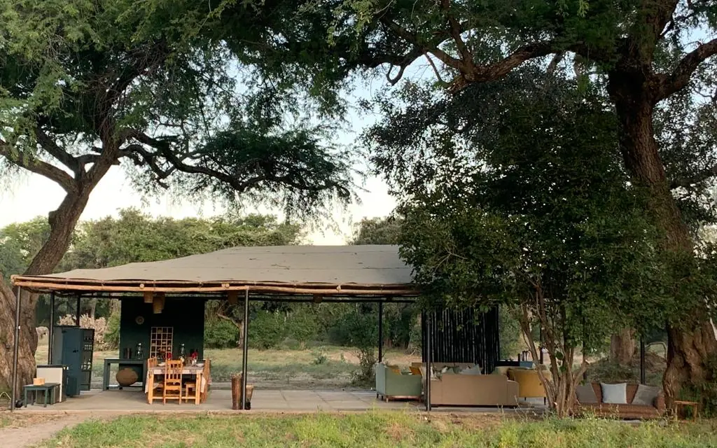 Open-air lodge pavilion beneath mature shade trees, Little Vundu, Mana Pools, Zimbabwe