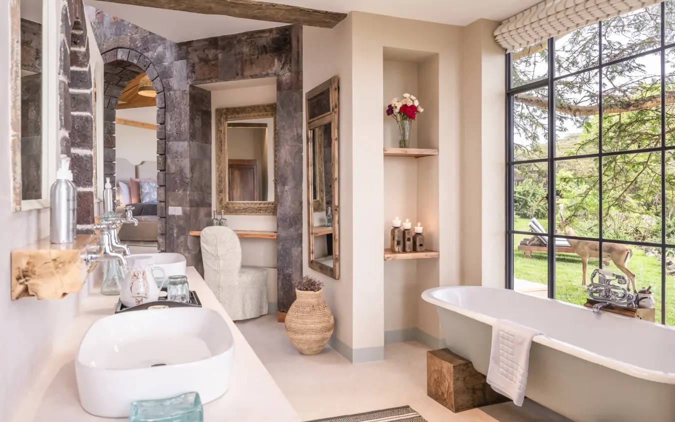 Luxury bathroom with freestanding tub and countryside views through large windows, Loldia House, Rift Valley Lakes, Kenya