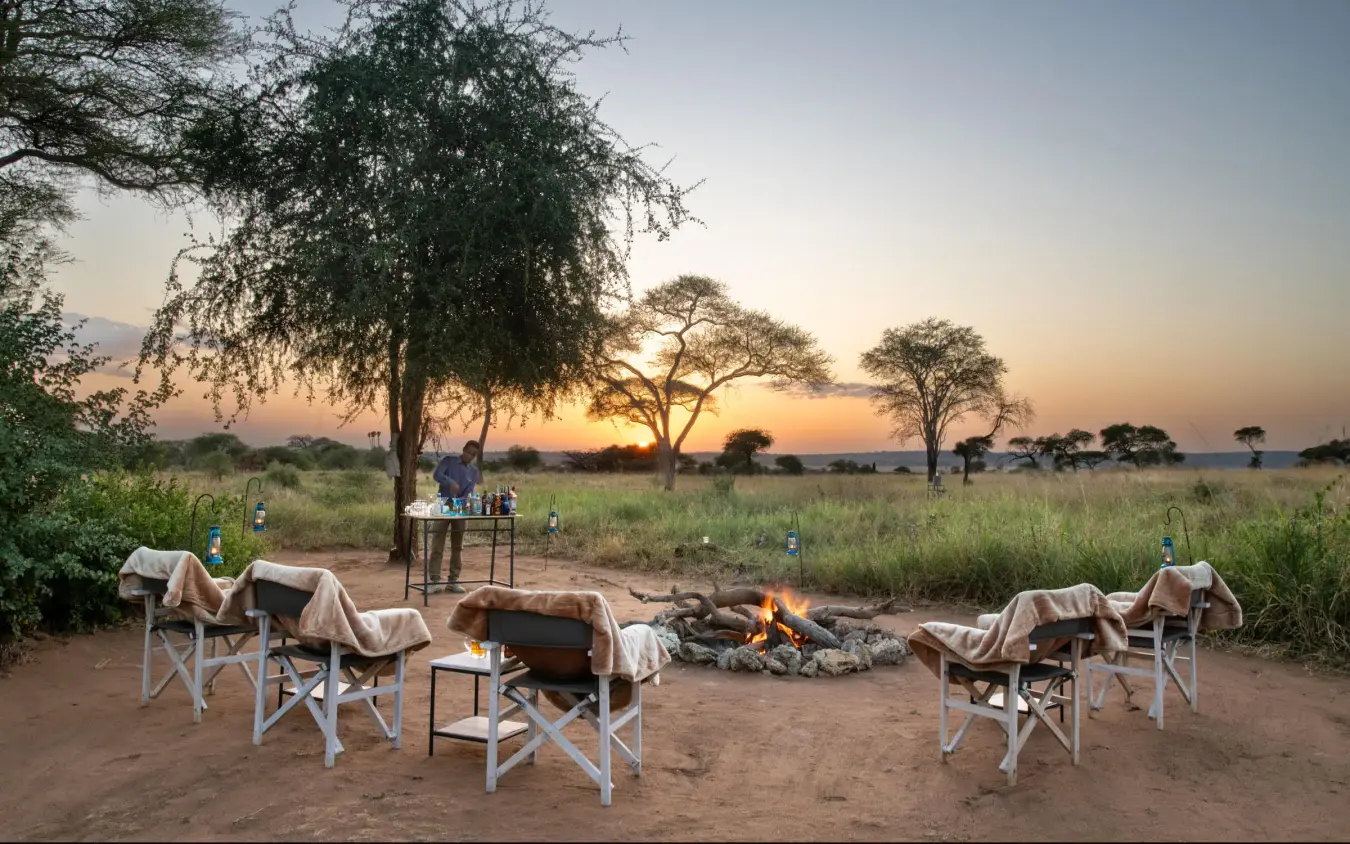 Safari camp seating area at sunset with acacia trees, Lolkisale Camp, Tarangire National Park, Tanzania