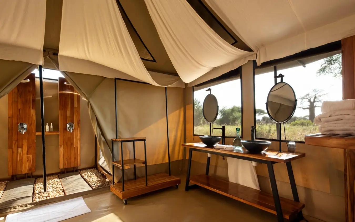 Safari tent interior with wooden furnishings and canvas walls, Lolkisale Camp, Tarangire National Park, Tanzania