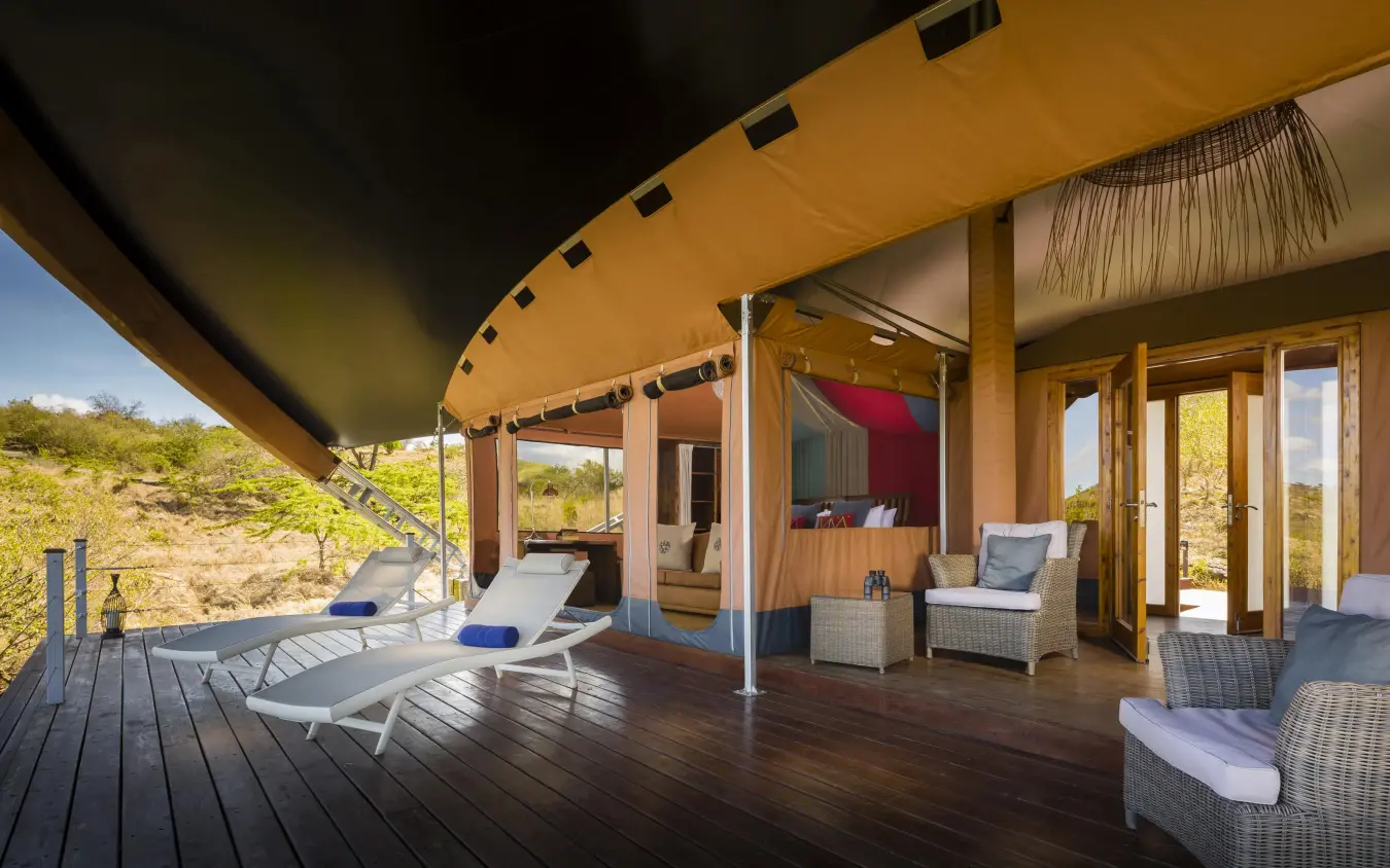 Spacious safari lodge deck with seating and canvas canopy, Mahali Mzuri, Maasai Mara, Kenya
