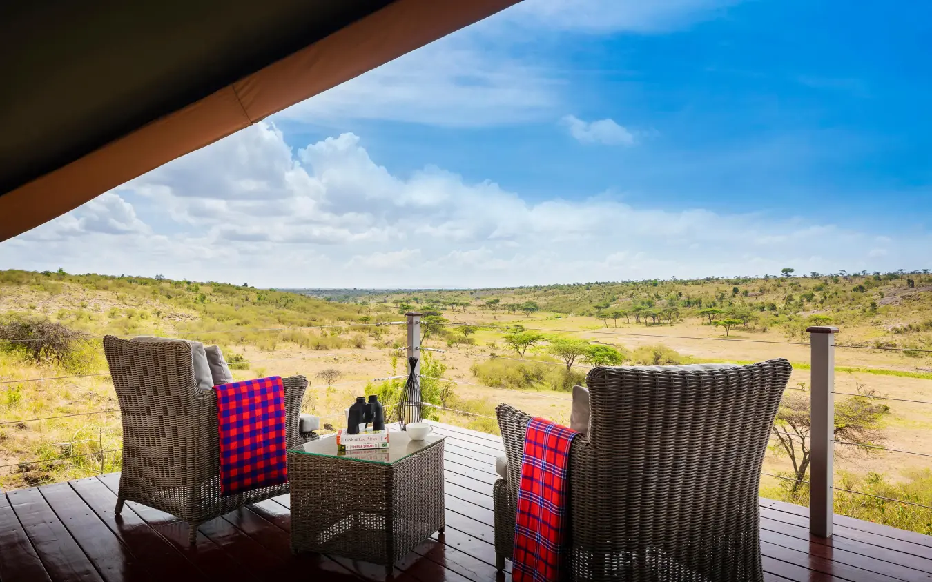 Covered deck with chairs overlooking savanna landscape, Mahali Mzuri, Maasai Mara, Kenya