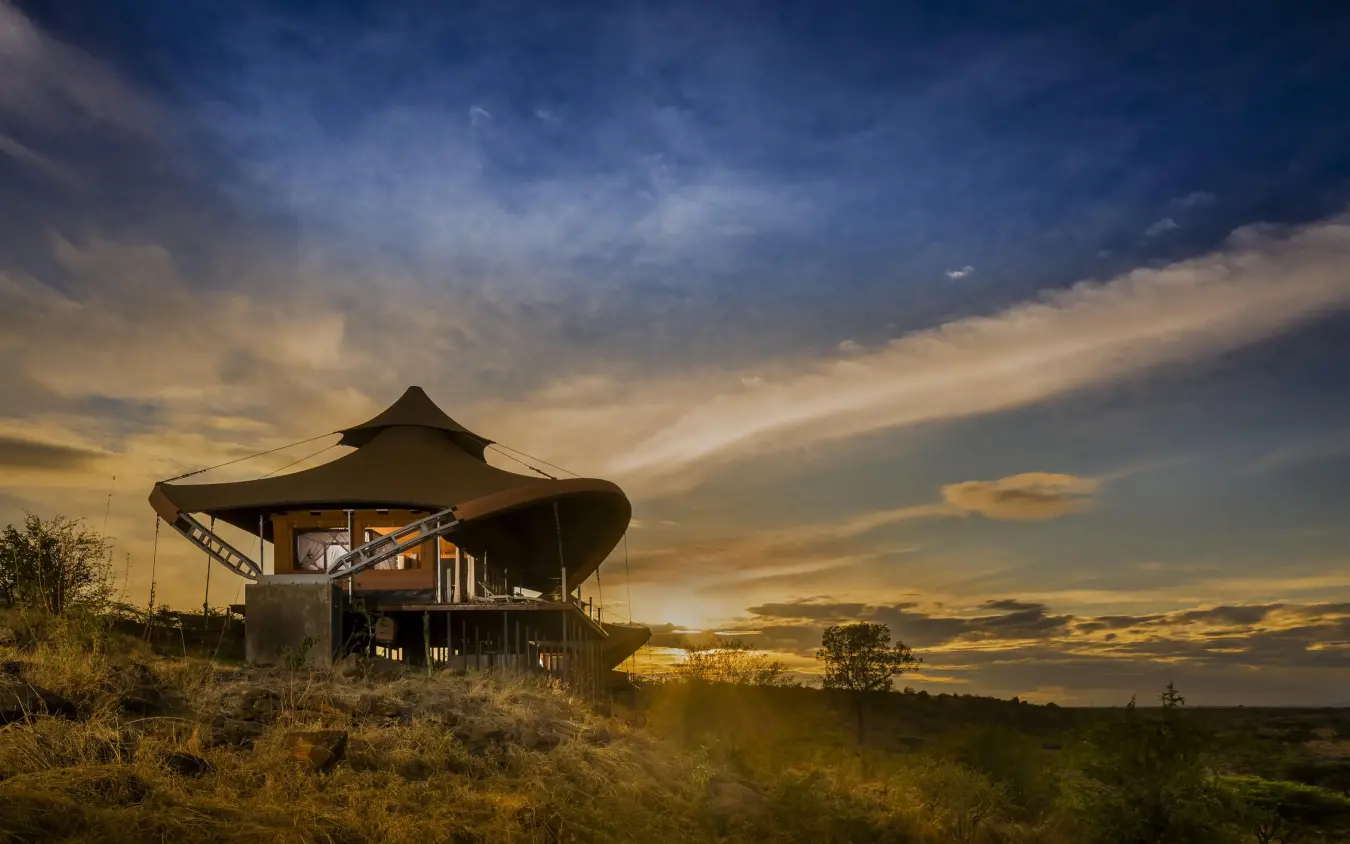 Elevated safari lodge at sunset with savanna landscape, Mahali Mzuri, Maasai Mara, Kenya