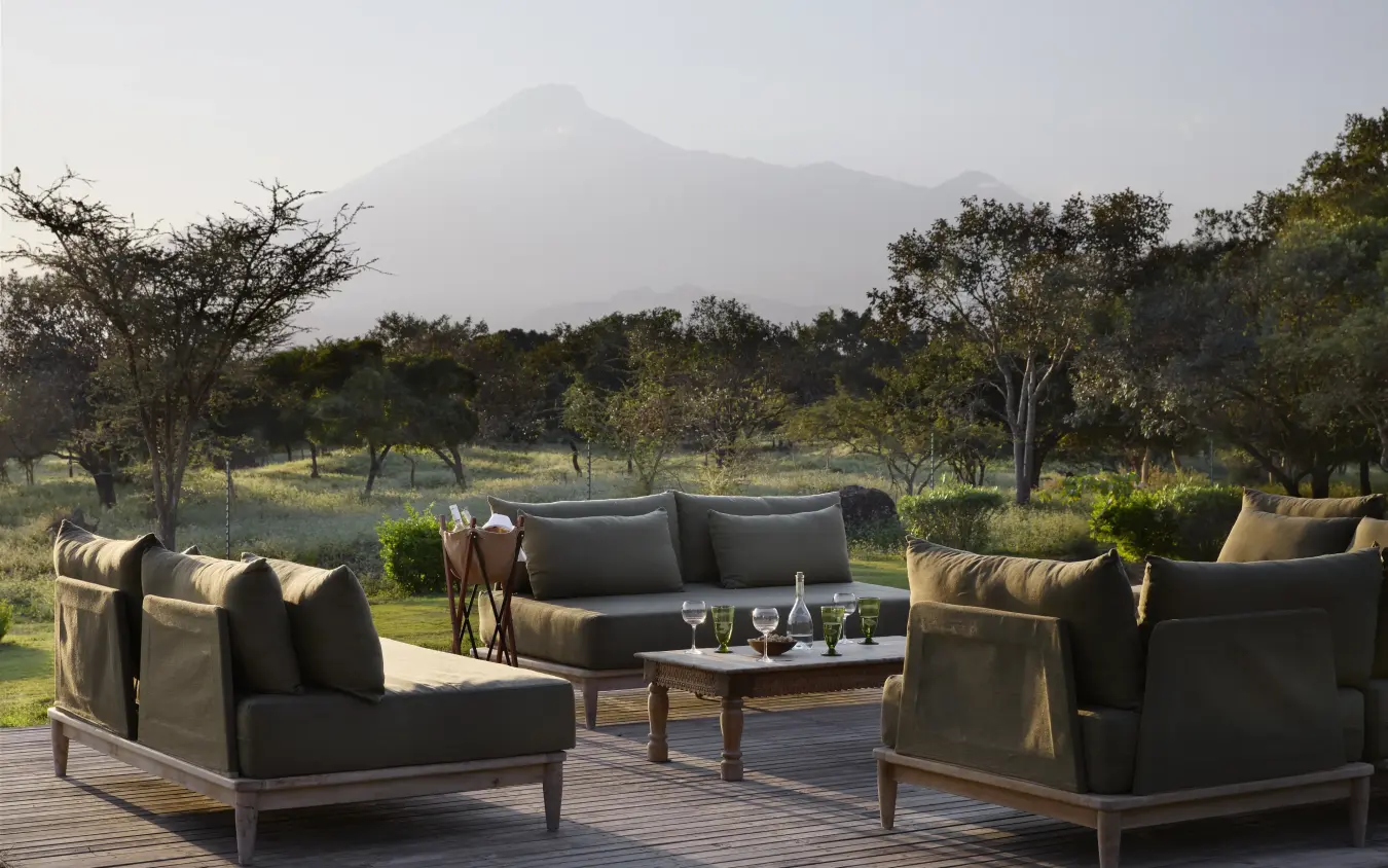 Outdoor lounge seating with volcano view across savanna landscape, Mama Simba, Arusha, Tanzania
