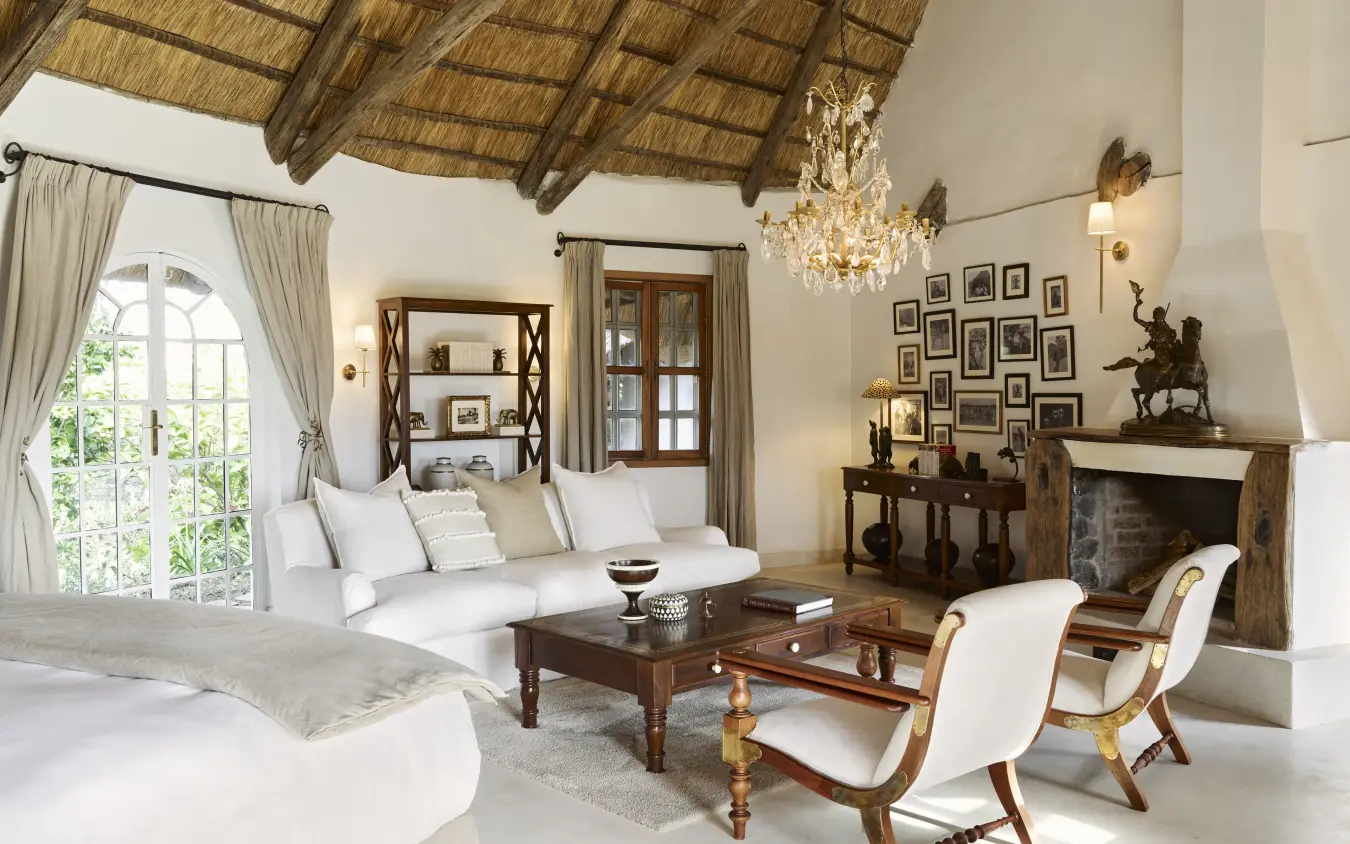 Luxury suite interior with thatched ceiling and fireplace overlooking gardens, Mama Simba, Arusha, Tanzania