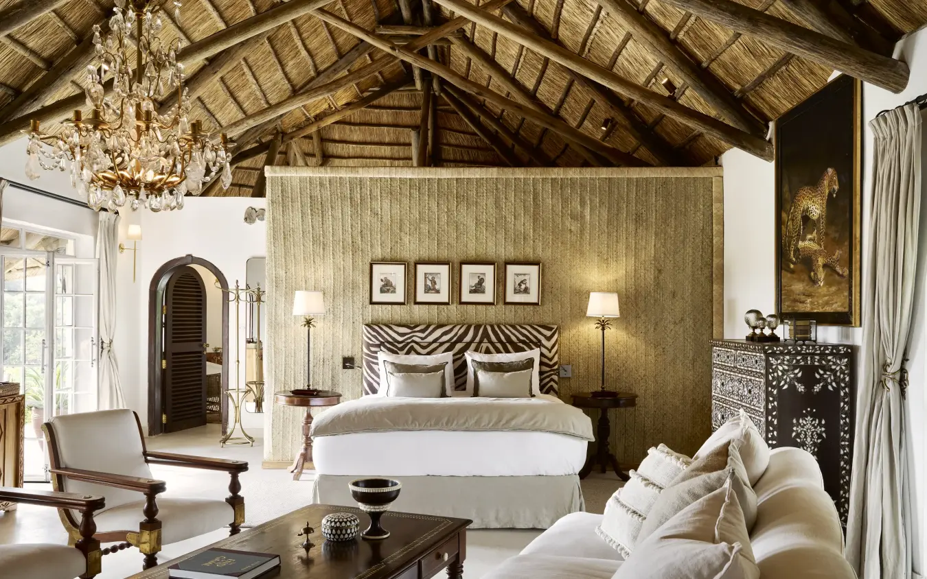 Luxurious bedroom suite with zebra-print headboard and ornate chandelier, Mama Simba, Arusha, Tanzania