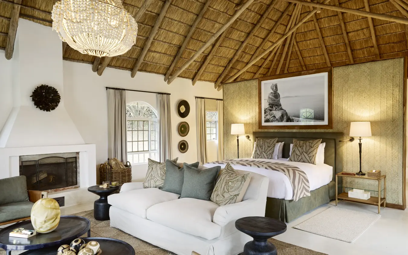Luxury bedroom suite with thatched roof and fireplace in safari lodge, Mama Simba, Arusha, Tanzania