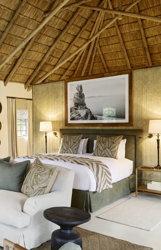 Luxury bedroom interior with thatched roof and safari-inspired décor, Mama Simba, Arusha, Tanzania