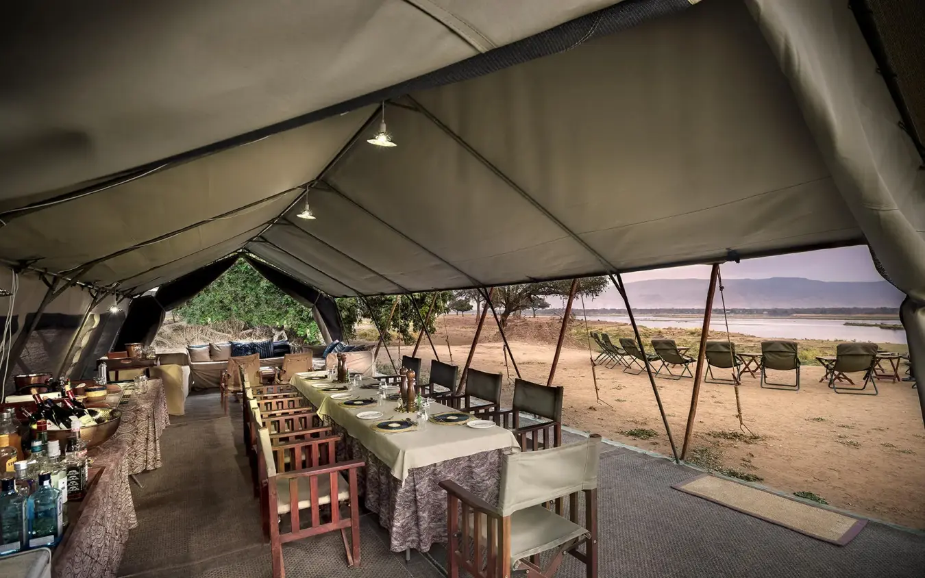 Dining tent setup with table settings overlooking landscape, Zambezi Expeditions, Mana Pools, Zimbabwe