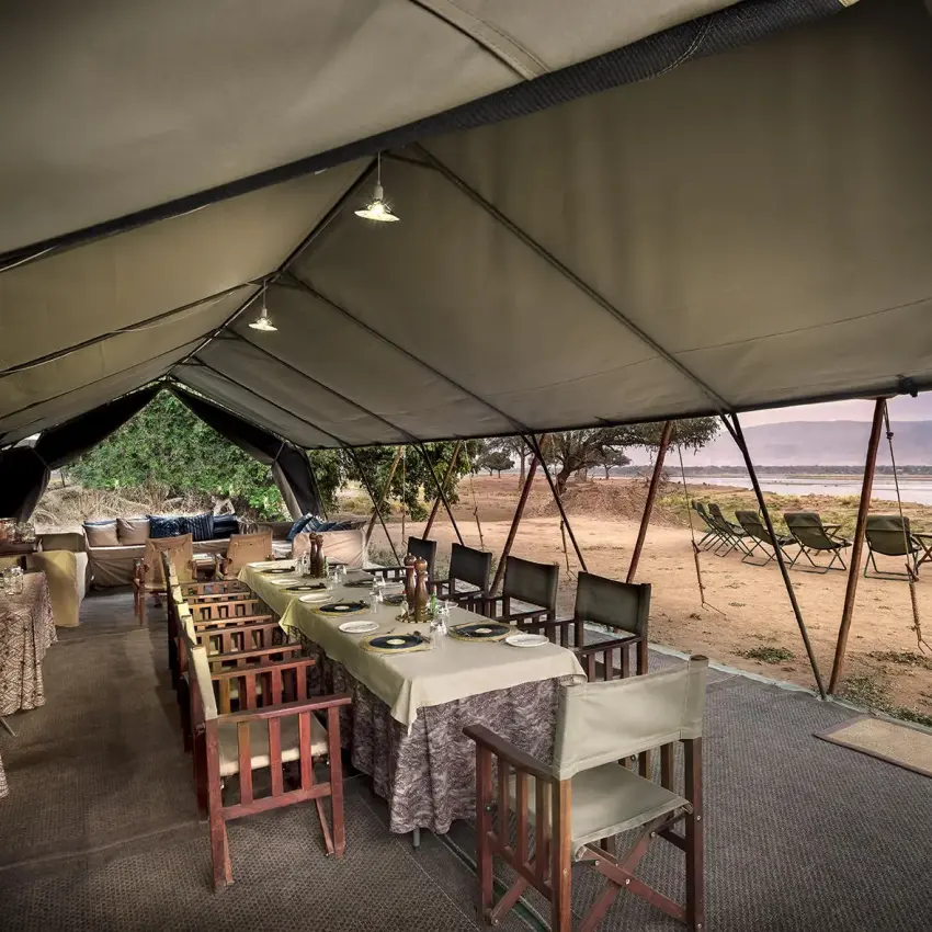 Dining tent setup with table settings overlooking landscape, Zambezi Expeditions, Mana Pools, Zimbabwe