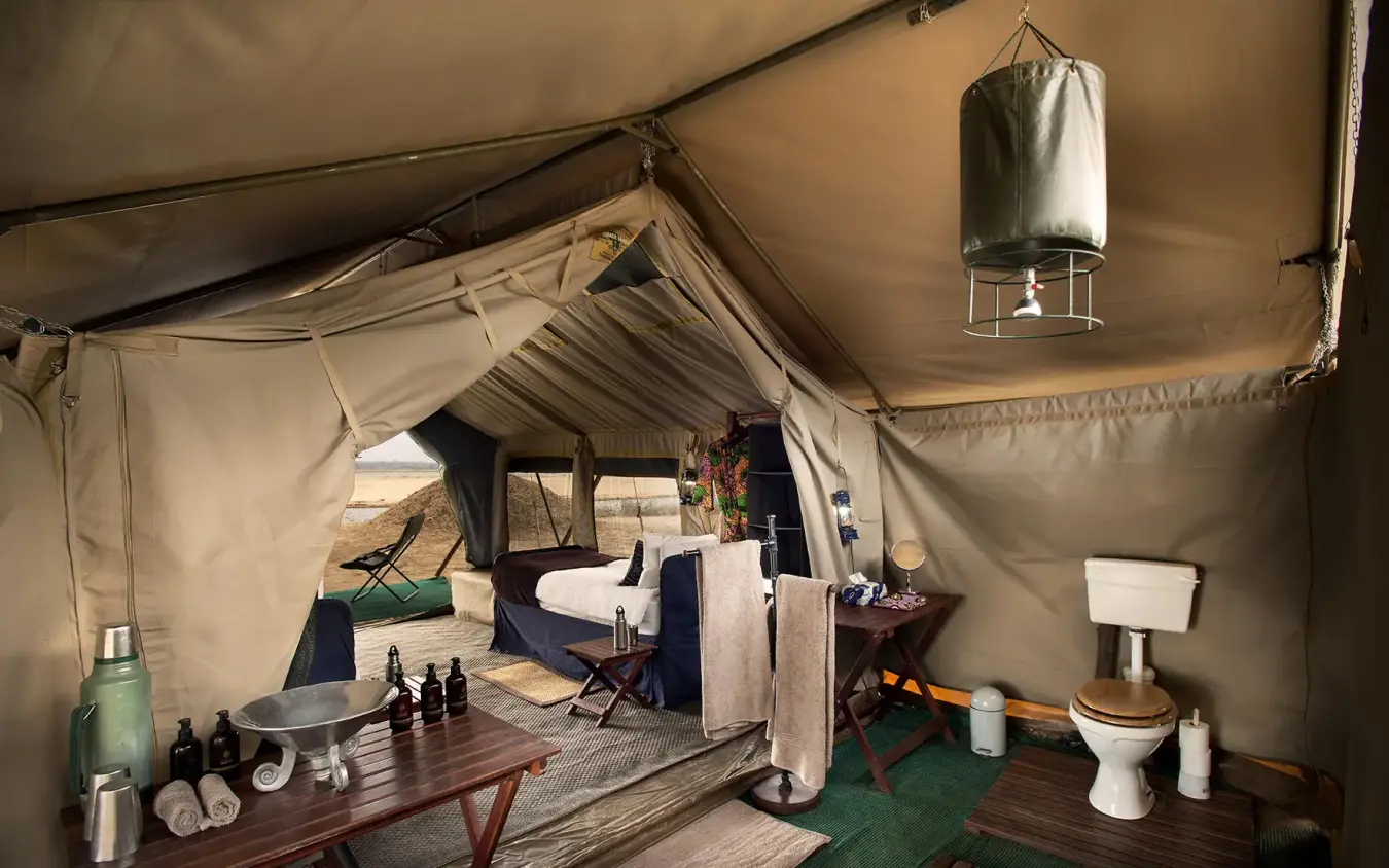 Safari tent interior with bed, bathroom, and furnishings, Zambezi Expeditions, Mana Pools, Zimbabwe