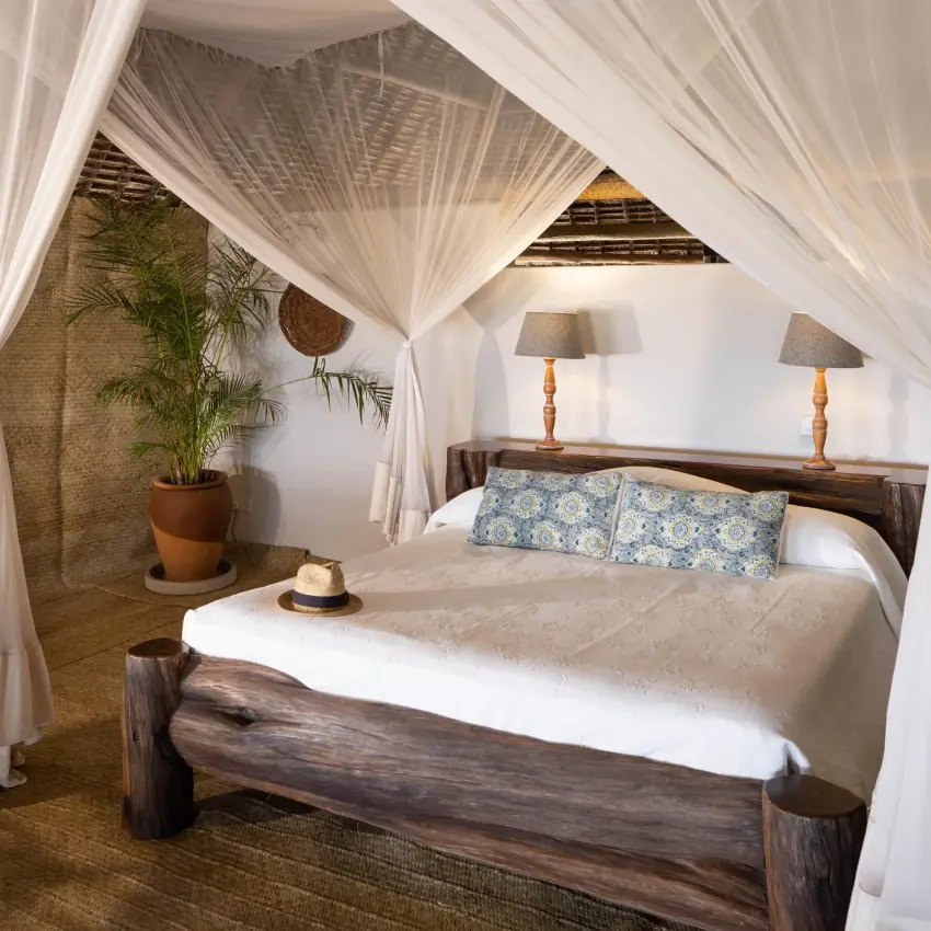 Bedroom with four-poster canopy bed and white drapes, Manda Bay, Lamu Archipelago, Kenya