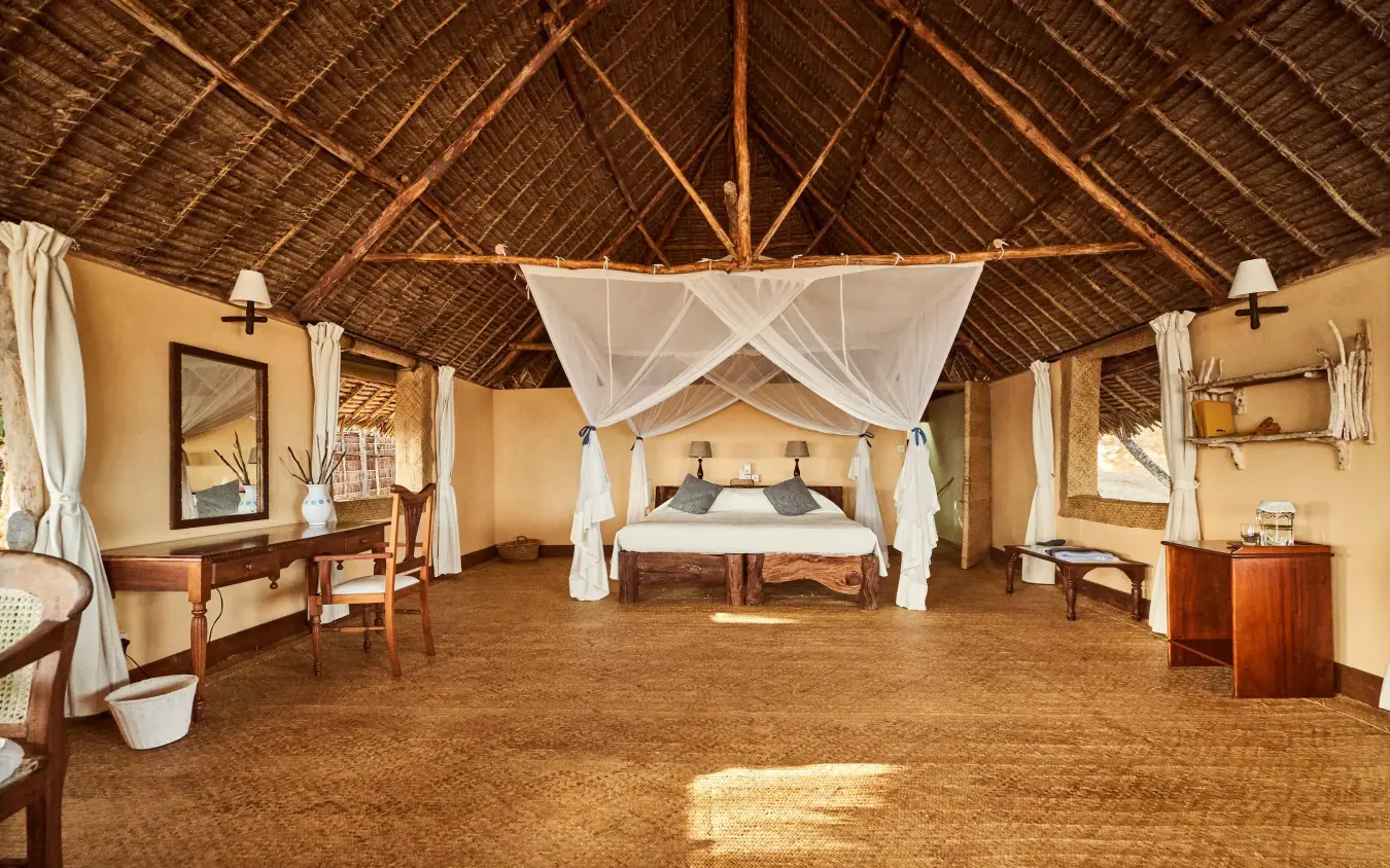 Spacious safari lodge bedroom with four-poster canopy bed, Manda Bay, Lamu Archipelago, Kenya