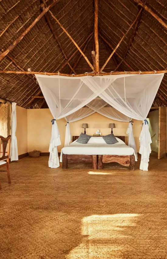Spacious safari lodge bedroom with four-poster canopy bed, Manda Bay, Lamu Archipelago, Kenya