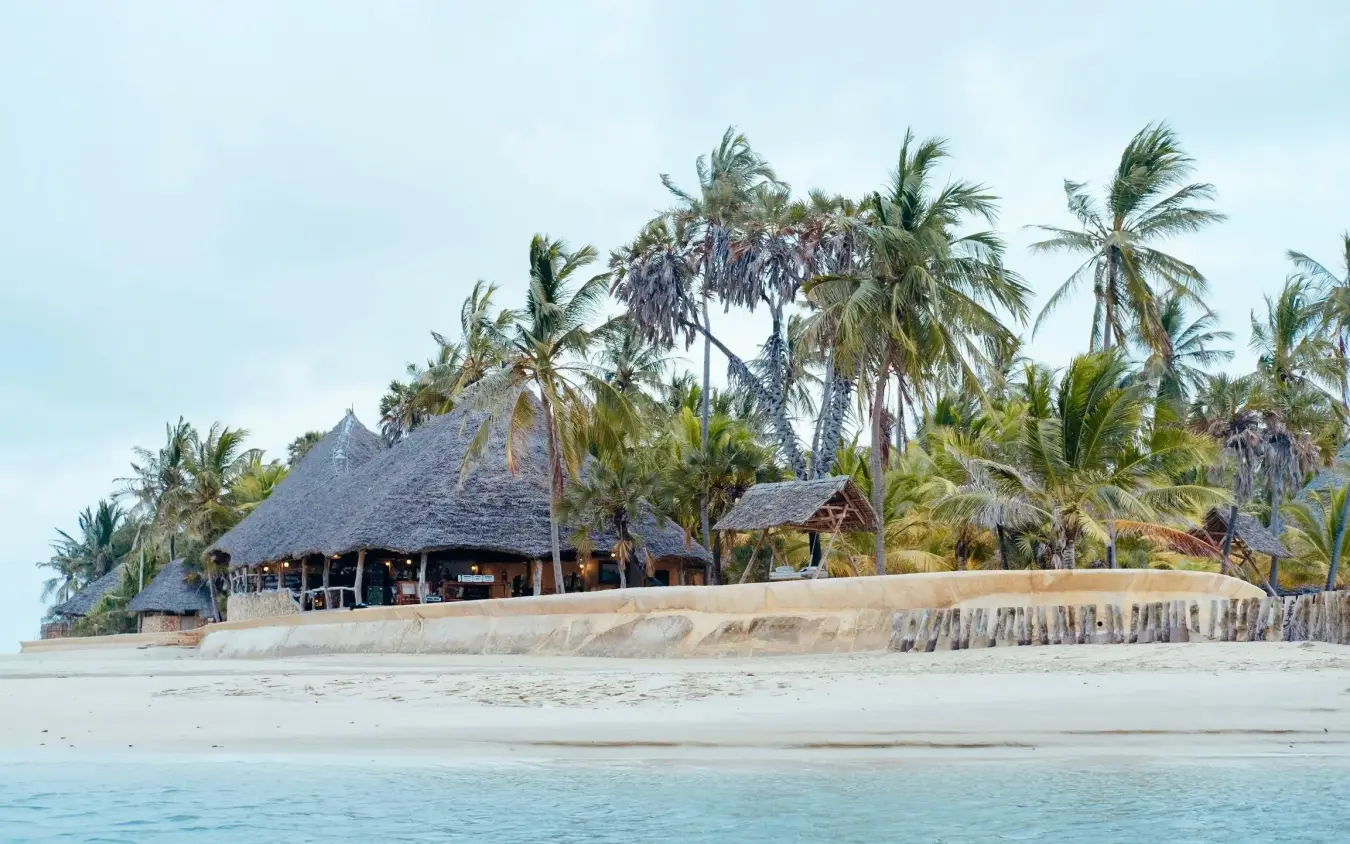 Beachfront lodge with thatched roof and palm trees, Manda Bay, Lamu Archipelago, Kenya
