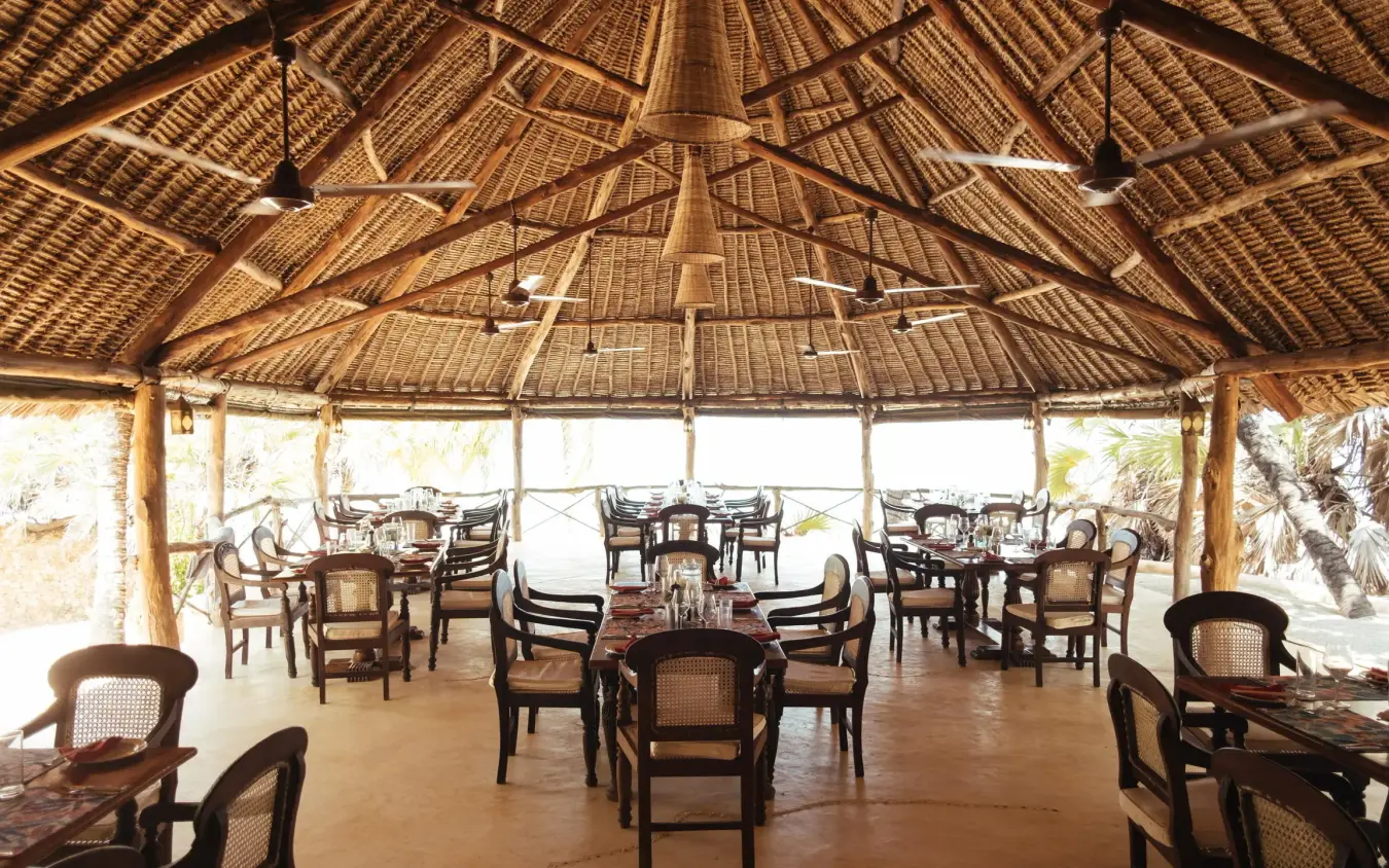 Open-air dining pavilion with thatched roof and wooden furnishings, Manda Bay, Lamu Archipelago, Kenya