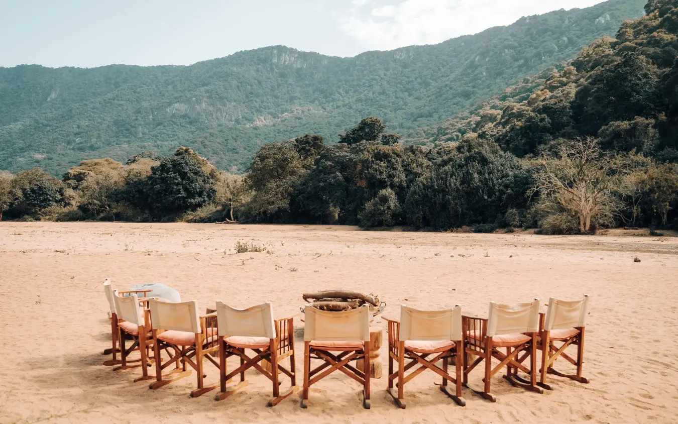 Canvas chairs arranged in circle on sandy beach, Manyara Green Camp, Lake Manyara, Tanzania