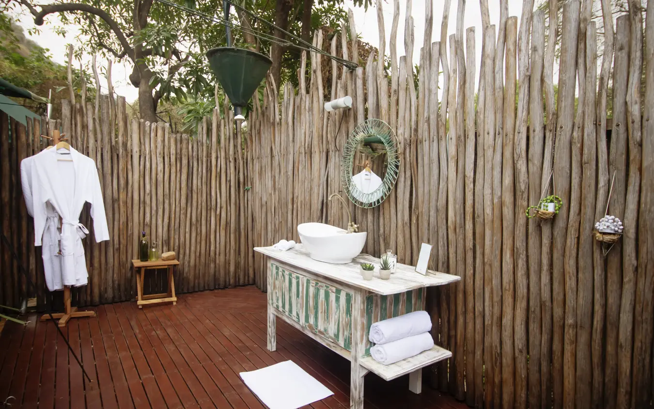 Outdoor bathroom with vessel sink and wooden pallet walls, Manyara Green Camp, Lake Manyara, Tanzania