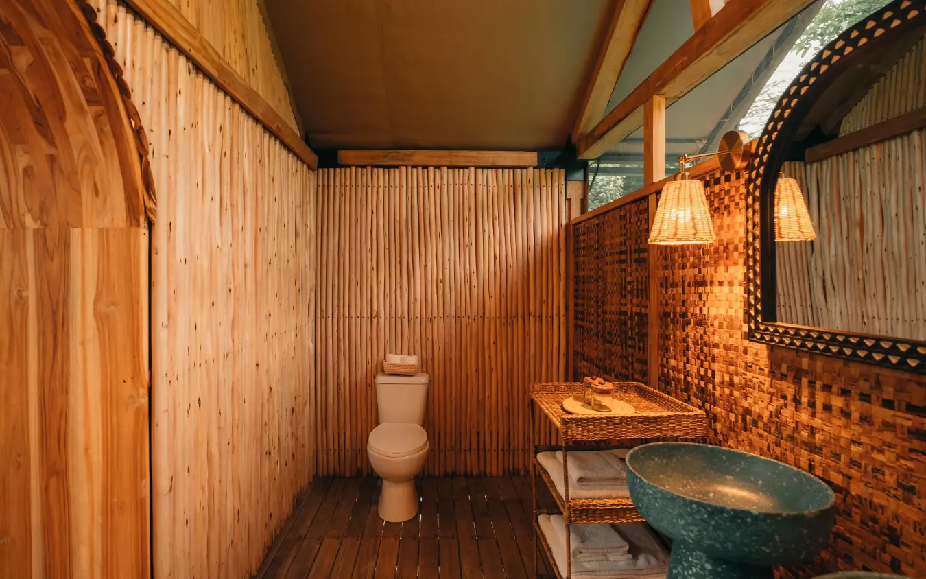 Rustic bathroom with wooden walls and stone sink basin, Manyara Green Camp, Lake Manyara, Tanzania