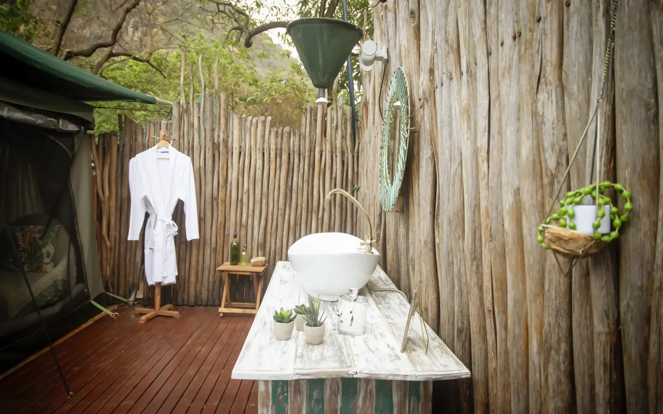Outdoor bathroom setup with basin and rustic wooden walls, Manyara Green Camp, Lake Manyara, Tanzania