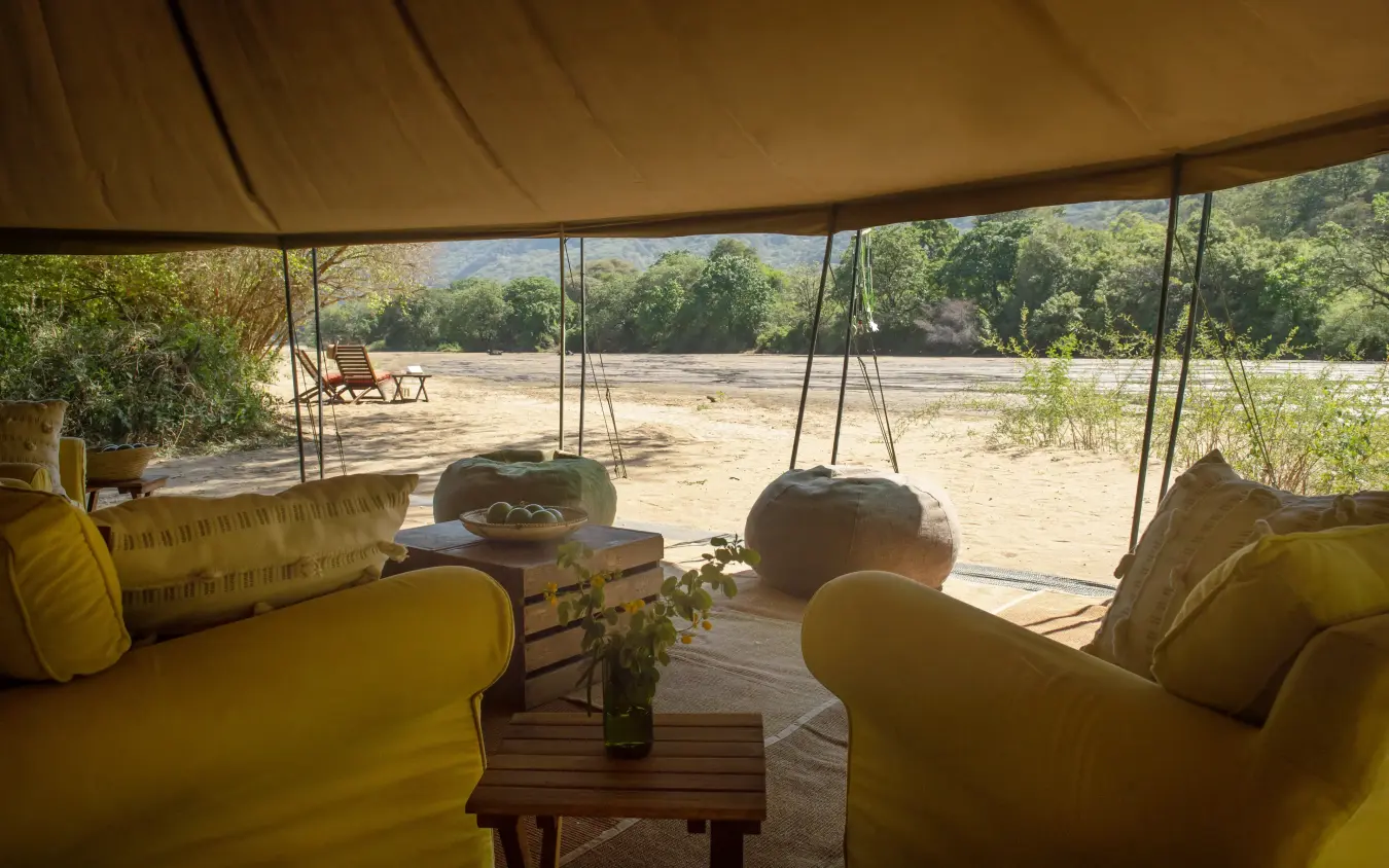 Safari lounge tent overlooking river and woodland landscape, Manyara Green Camp, Lake Manyara, Tanzania