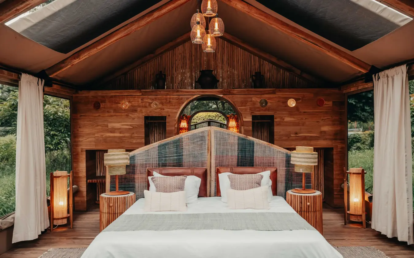 Wooden bedroom pavilion with four-poster bed and pendant lights, Manyara Green Camp, Lake Manyara, Tanzania