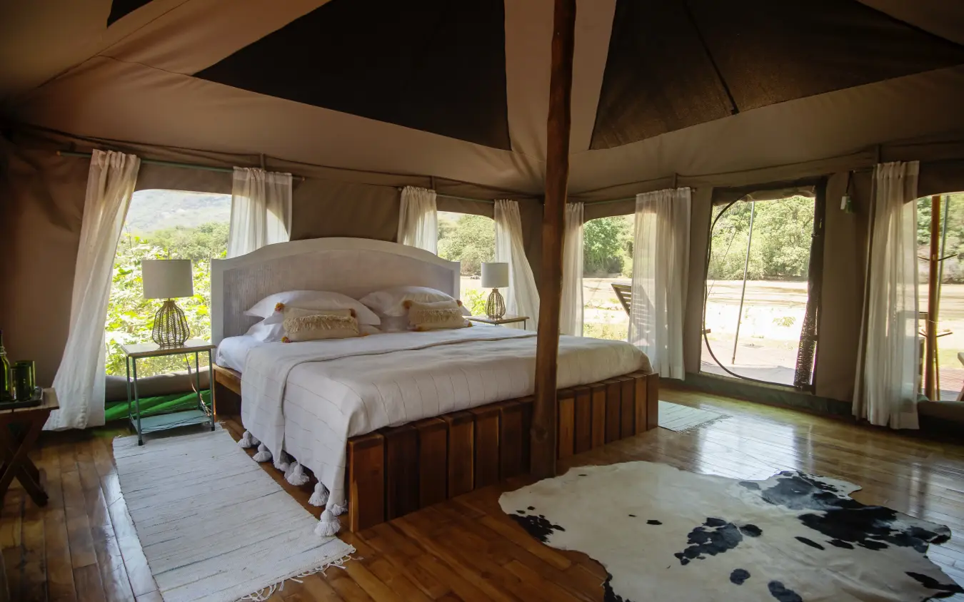 Spacious bedroom with canopy bed and canvas walls, Manyara Green Camp, Lake Manyara, Tanzania