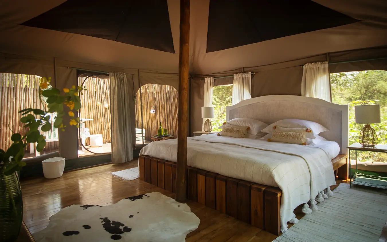 Spacious bedroom with four-poster bed and canvas walls, Manyara Green Camp, Lake Manyara, Tanzania